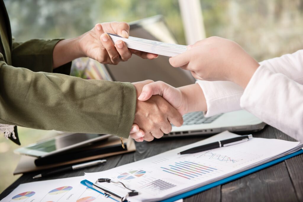 business people shaking hands finishing up meeting 1 1.jpg